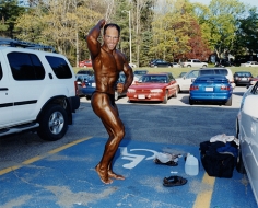 Man applying tanning lotion before a bodybuilding competition, Worcester, MA, 2003