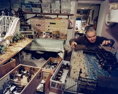 Man in his basement with models of North End businesses, including his barbershop, Boston, MA, 2003