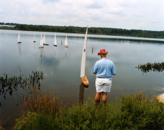Man at radio-controlled sailboat regatta, Gilford, NH, 2003